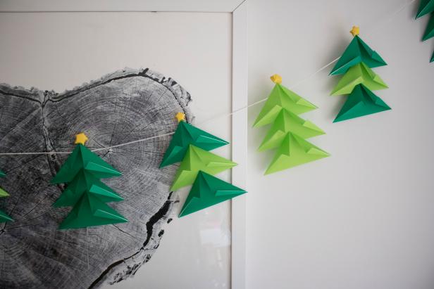 Fold paper Christmas trees and top them with origami stars.