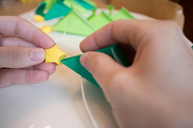 Fold paper Christmas trees and top them with origami stars.