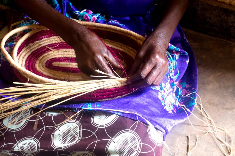 Close up of Woman Weaving a Basket in Her Lap