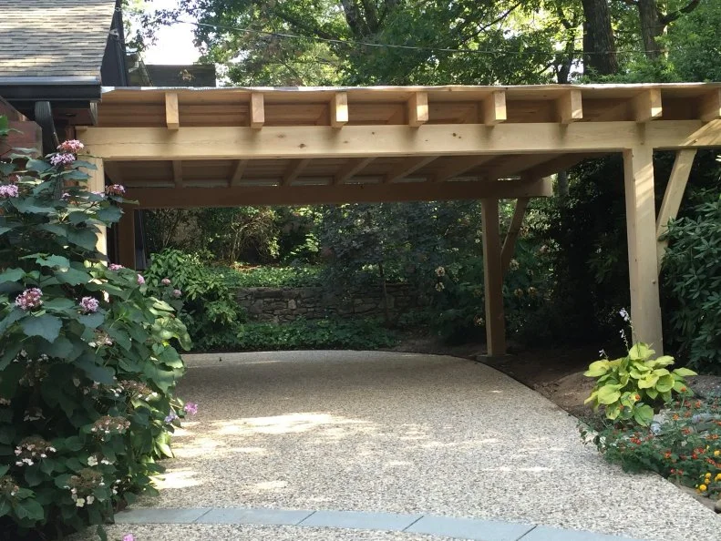 Wooden Structure With Beams Exposed and Greenery All Around