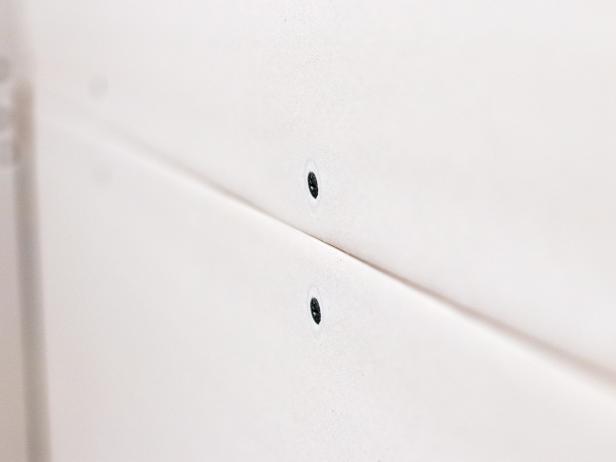 Feel the screw heads to make sure none are sticking above the surface of the drywall.