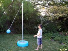 Bring the fun of the schoolyard into your backyard with a tetherball court. Made inexpensively from an upcycled tire and a metal pole, this tetherball game can be rolled around the yard to play in the sun or shade.