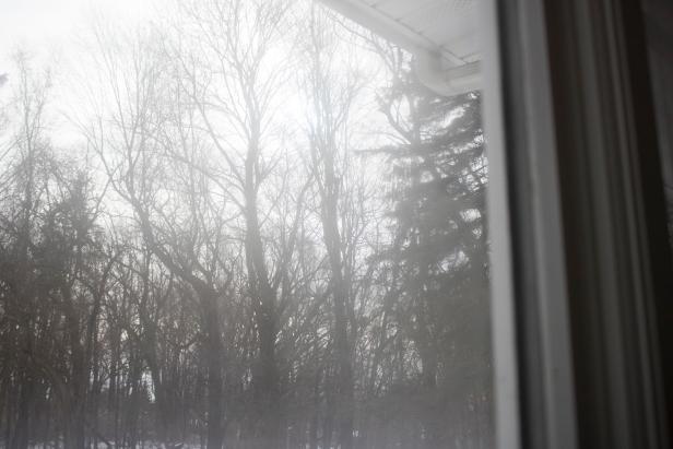 Condensation and fogginess inside a damaged thermopane window.