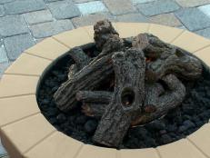 A gas firepit is placed on the patio.