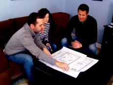 Contractor Jeff Devlin meets with homeowners as they talk about which design plan they liked the best for their basement redesign.
